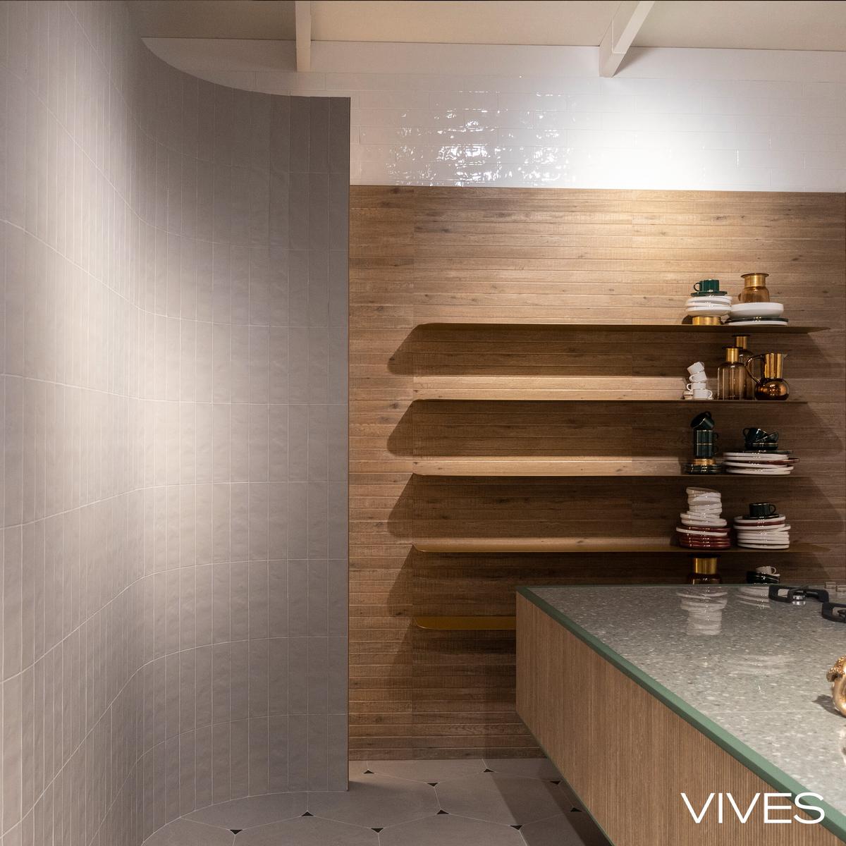Carrelage imitation béton beige lisse sur une salle de bain avec étagères en bois et accessoires décoratifs
