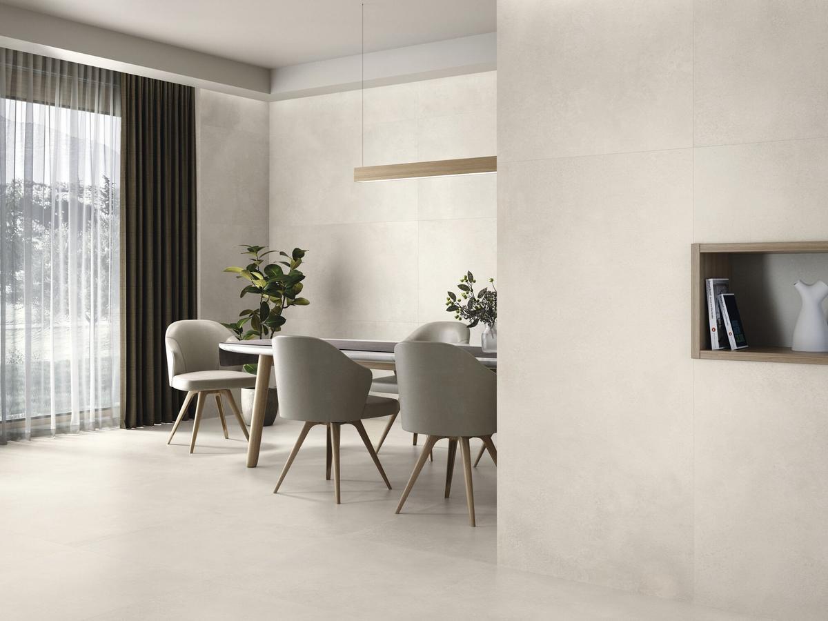 Carrelage effet béton beige lisse 60x120 cm installé dans une salle à manger contemporaine tons neutres, mobilier moderne beige et accents bois