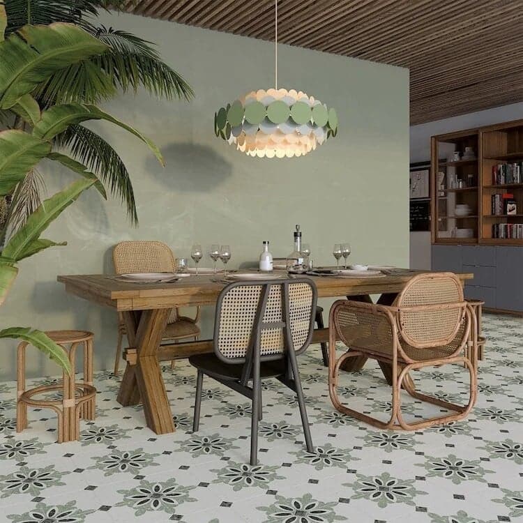 Carrelage Terrazzo vert avec des motifs floraux en 20x20 cm dans une salle à manger aux murs verts et meubles en bois et rotin