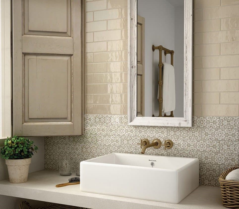 Carrelage beige uni avec motifs floraux dans une salle de bain tons crème, avec lavabo blanc et accessoires vintage