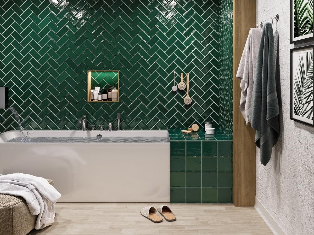 Carrelage uni vert émeraude 7,5x15 cm dans une salle de bain tons neutres avec baignoire, serviettes et décoration murale