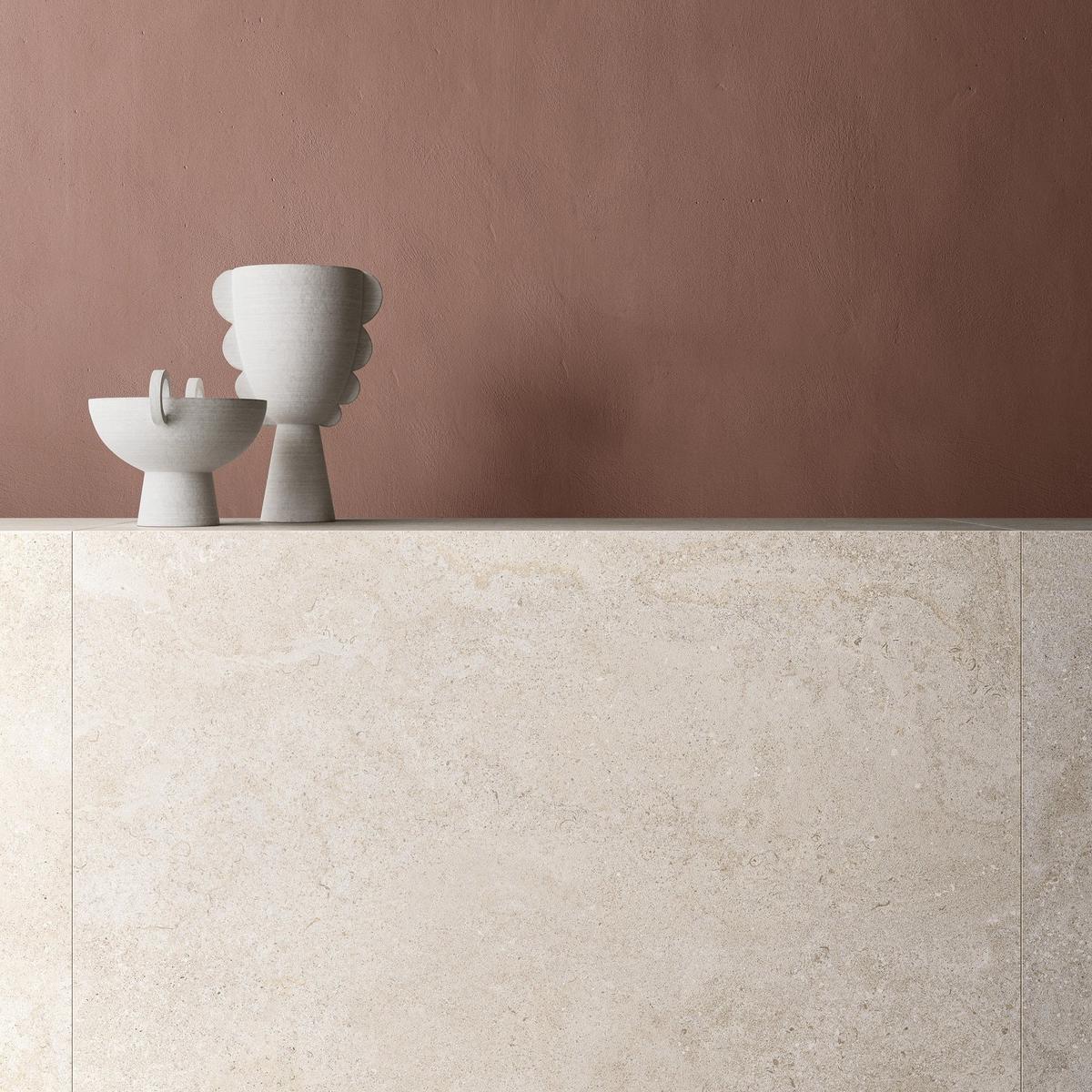 Carrelage effet pierre blanc sans motifs 60x60 cm dans une cuisine ton terracotta avec objets décoratifs modernes